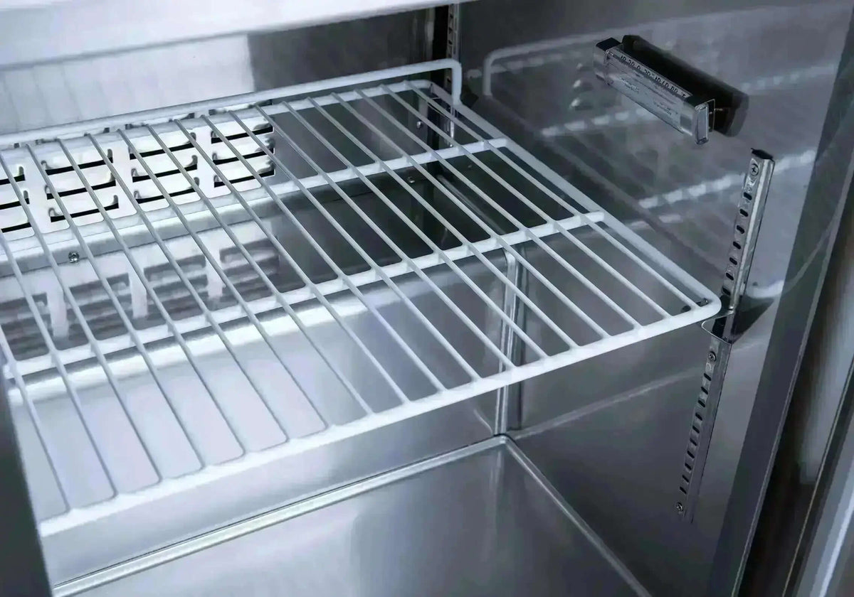 Interior view of the SCLM1 Refrigerated Mega Top Prep Table showing the wire shelving.